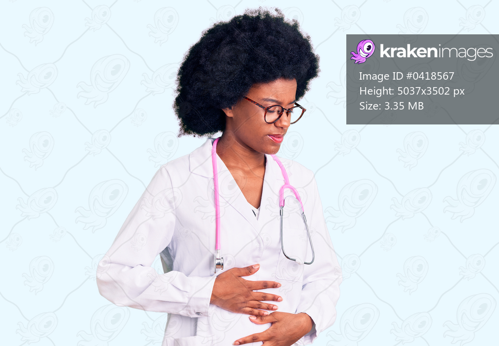 Young african american woman wearing doctor coat and stethoscope with hand on stomach because indigestion, painful illness feeling unwell. ache concept. 