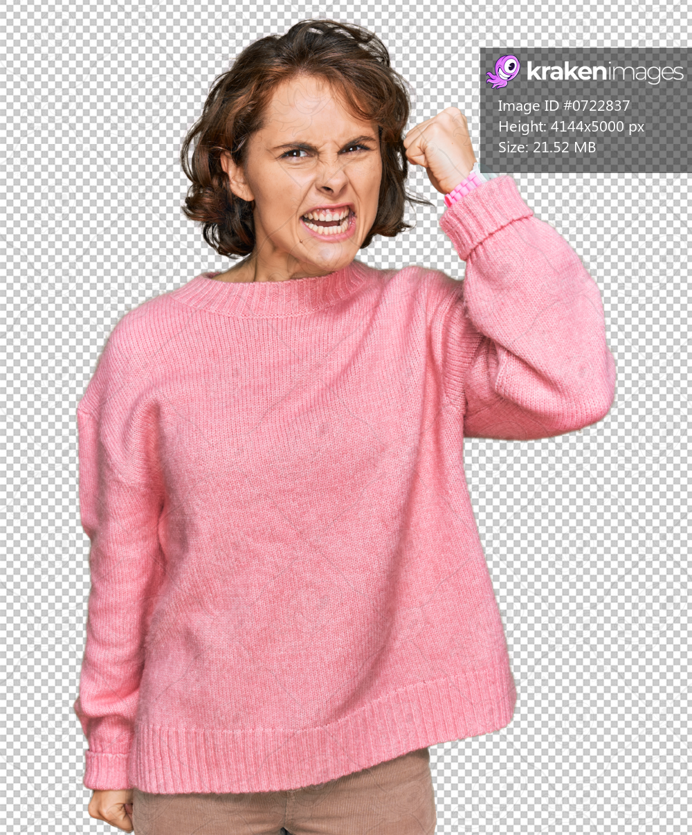 Young hispanic woman wearing casual clothes angry and mad raising fist frustrated and furious while shouting with anger. rage and aggressive concept.