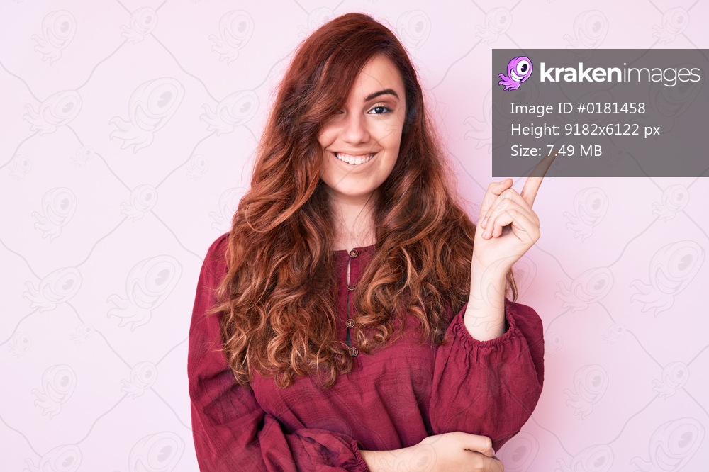 Young beautiful woman wearing casual winter sweater smiling happy pointing with hand and finger to the side 