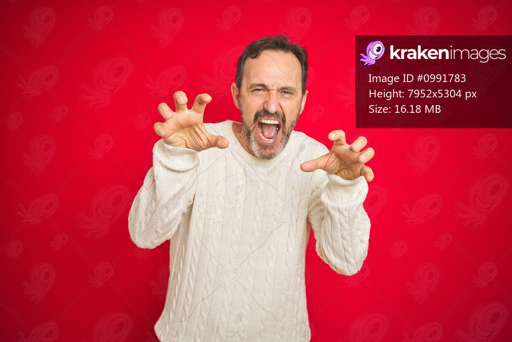 Handsome middle age senior man with grey hair over isolated red background smiling funny doing claw gesture as cat, aggressive and sexy expression