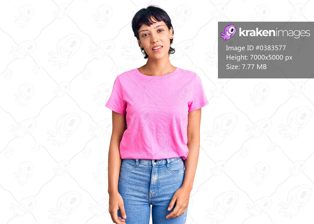 Young brunette woman with short hair wearing casual clothes relaxed with serious expression on face. simple and natural looking at the camera. 