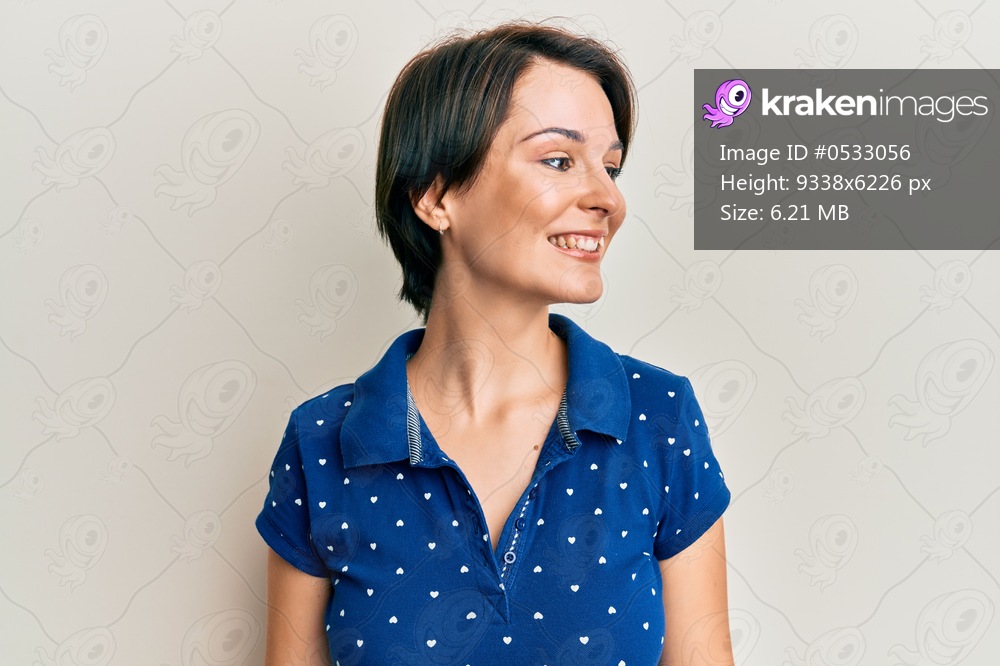 Young brunette woman with short hair wearing casual clothes looking to side, relax profile pose with natural face and confident smile. 