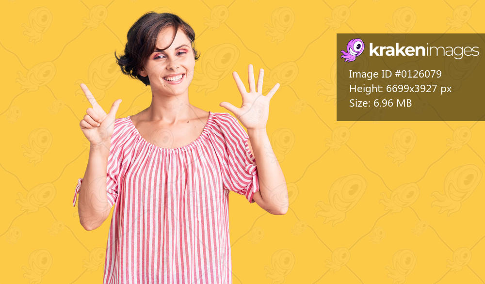 Beautiful young woman with short hair wearing casual summer clothes showing and pointing up with fingers number seven while smiling confident and happy. 