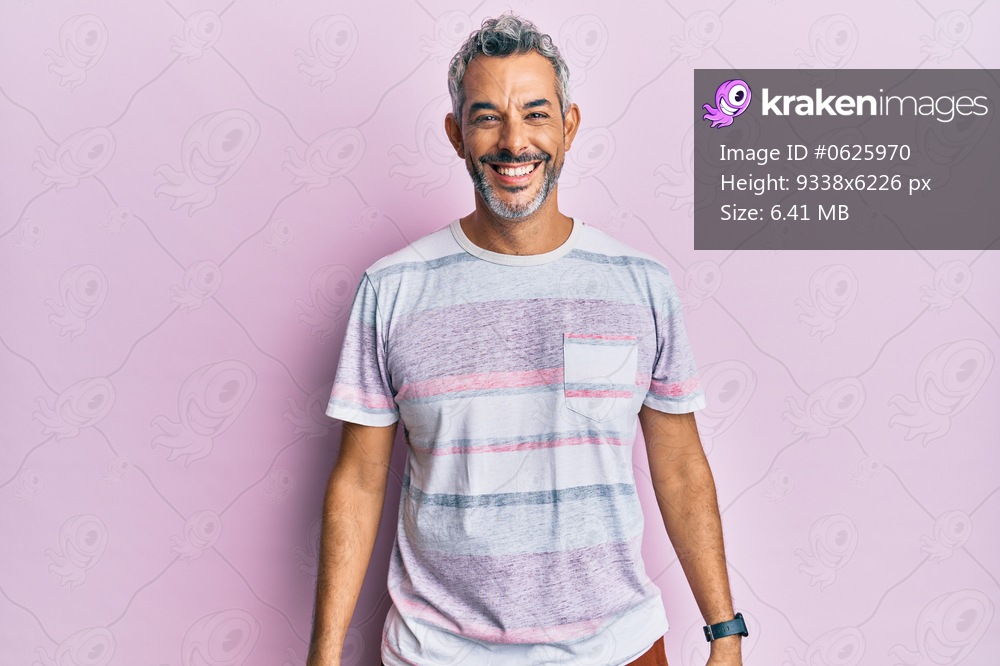 Middle age grey-haired man wearing casual clothes looking positive and happy standing and smiling with a confident smile showing teeth 