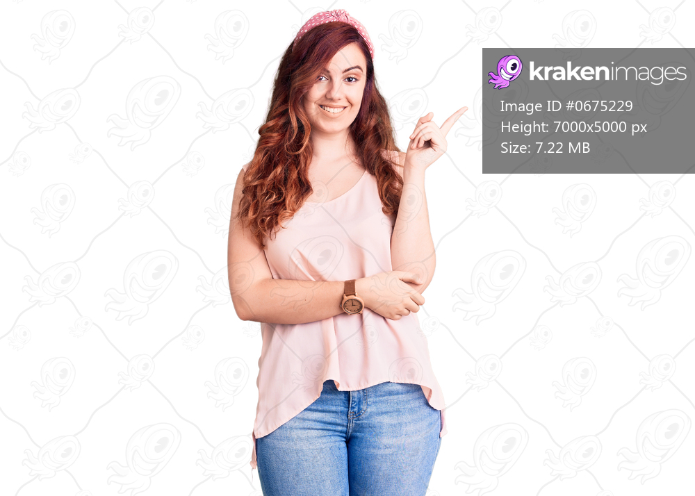 Young beautiful woman wearing casual clothes and diadem smiling happy pointing with hand and finger to the side 