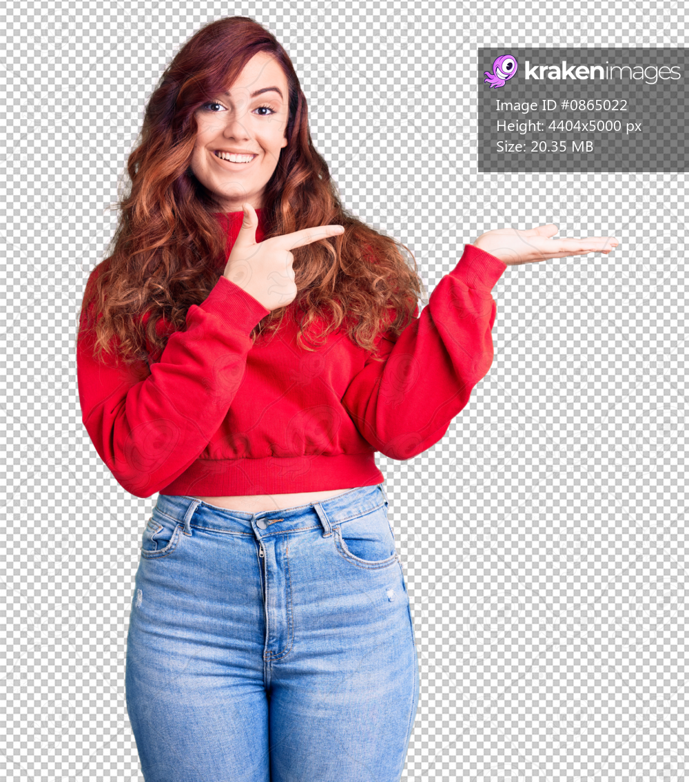 Young beautiful woman wearing casual winter sweater amazed and smiling to the camera while presenting with hand and pointing with finger.