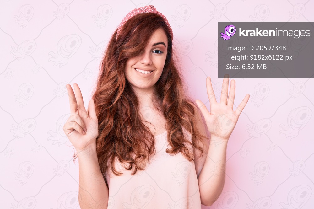 Young beautiful woman wearing casual clothes showing and pointing up with fingers number eight while smiling confident and happy. 