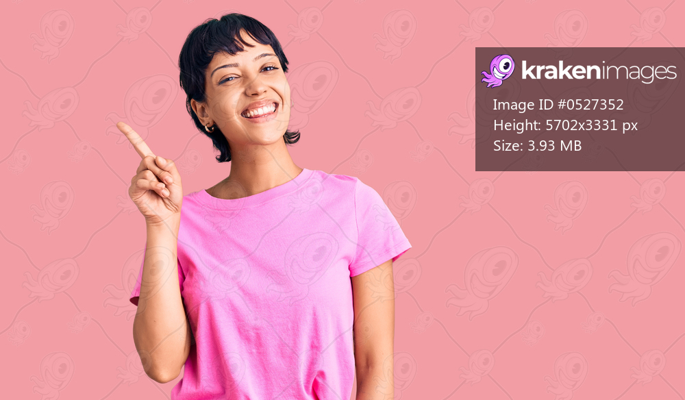 Young brunette woman with short hair wearing casual clothes showing and pointing up with finger number one while smiling confident and happy. 