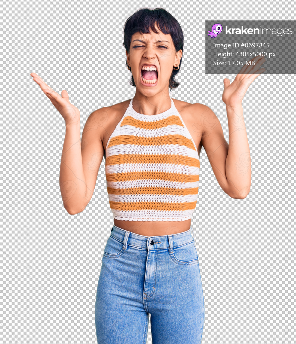 Young brunette woman with short hair wearing casual clothes celebrating mad and crazy for success with arms raised and closed eyes screaming excited. winner concept