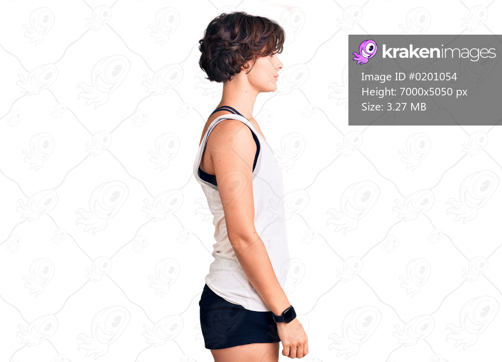 Beautiful young woman with short hair wearing casual sport clothes looking to side, relax profile pose with natural face with confident smile. 