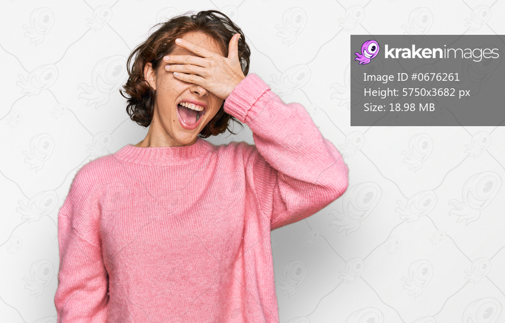 Young hispanic woman wearing casual clothes smiling and laughing with hand on face covering eyes for surprise. blind concept. 