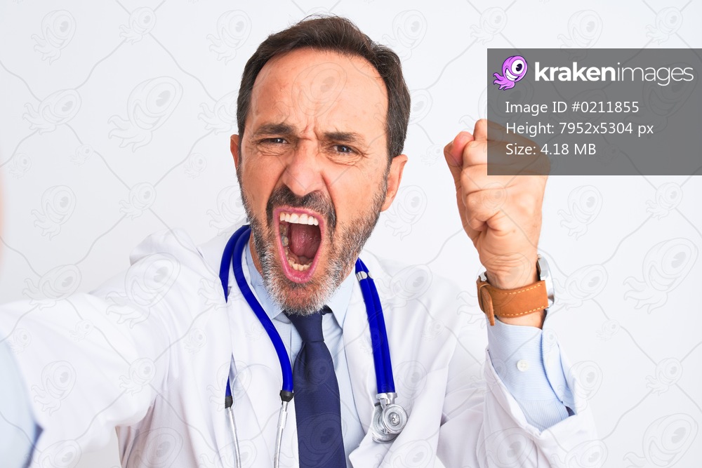 Middle age doctor man wearing stethoscope make selfie over isolated white background annoyed and frustrated shouting with anger, crazy and yelling with raised hand, anger concept