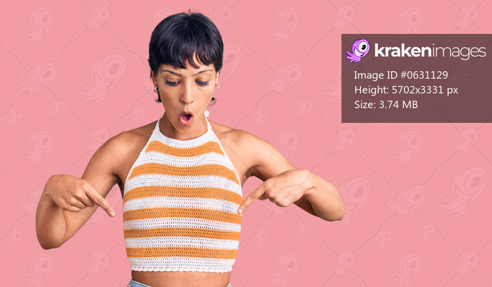 Young brunette woman with short hair wearing casual clothes pointing down with fingers showing advertisement, surprised face and open mouth 