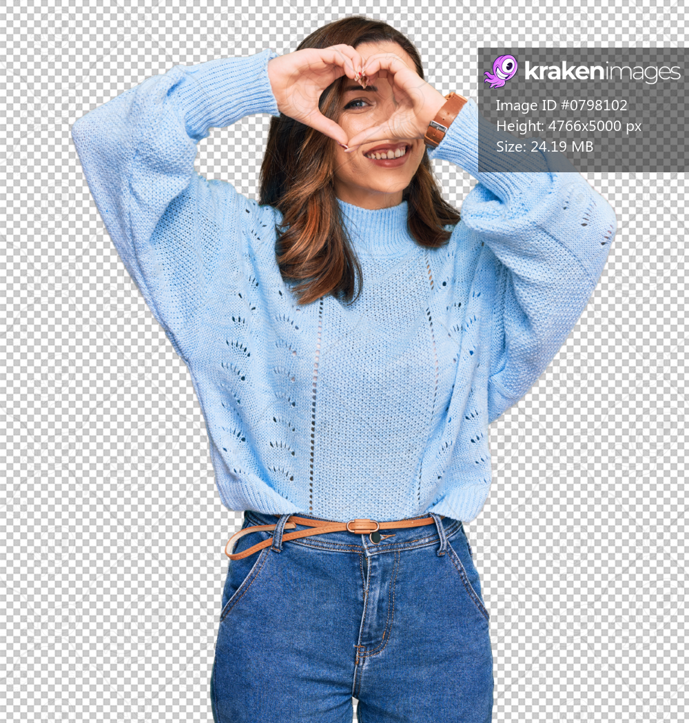 Young brunette woman wearing casual winter sweater doing heart shape with hand and fingers smiling looking through sign