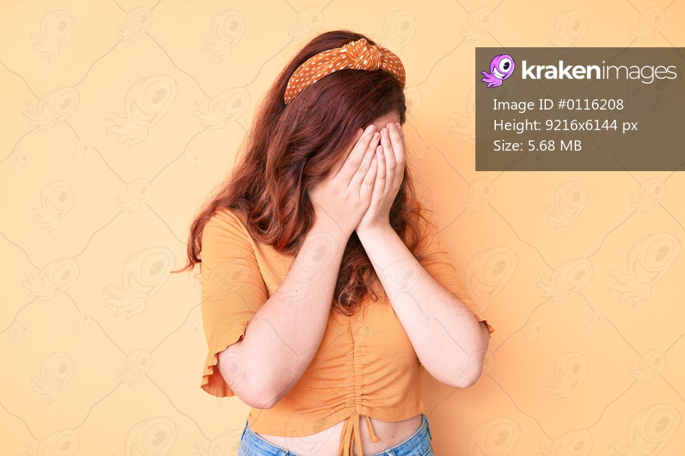 Young beautiful woman wearing casual clothes with sad expression covering face with hands while crying. depression concept. 