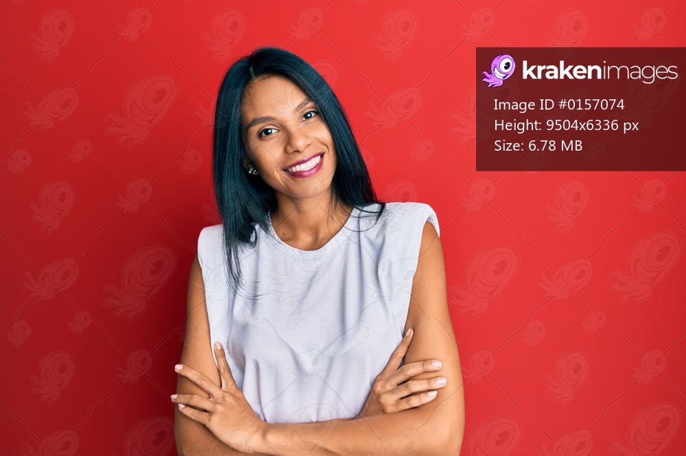 Young african american woman wearing casual clothes happy face smiling with crossed arms looking at the camera. positive person. 
