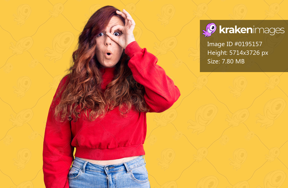 Young beautiful woman wearing casual winter sweater doing ok gesture shocked with surprised face, eye looking through fingers. unbelieving expression. 