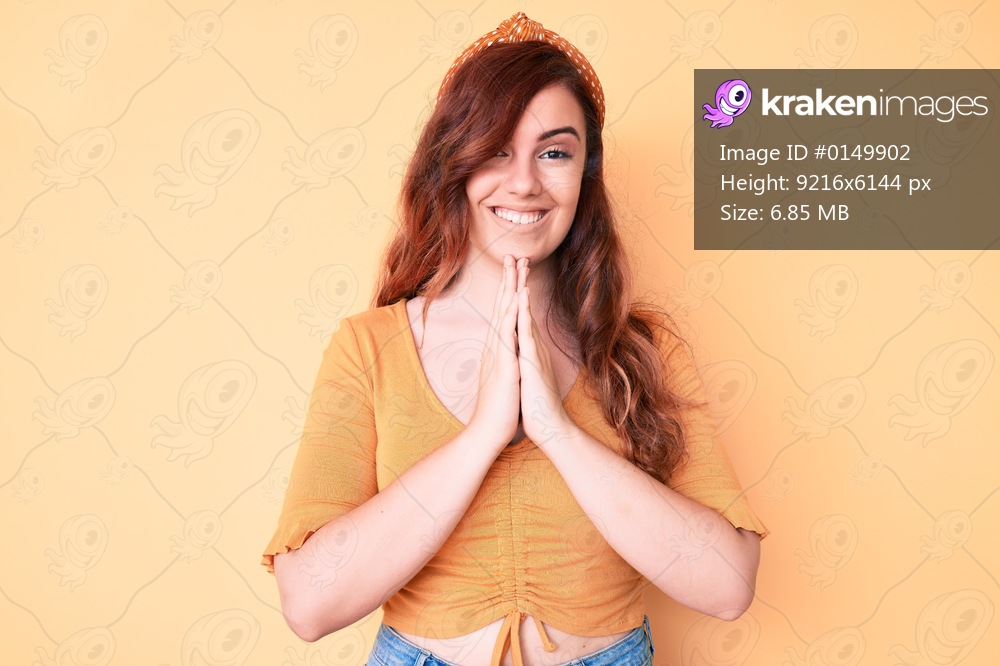 Young beautiful woman wearing casual clothes praying with hands together asking for forgiveness smiling confident. 