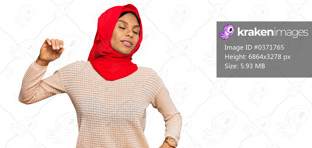 Young african american woman wearing traditional islamic hijab scarf stretching back, tired and relaxed, sleepy and yawning for early morning 