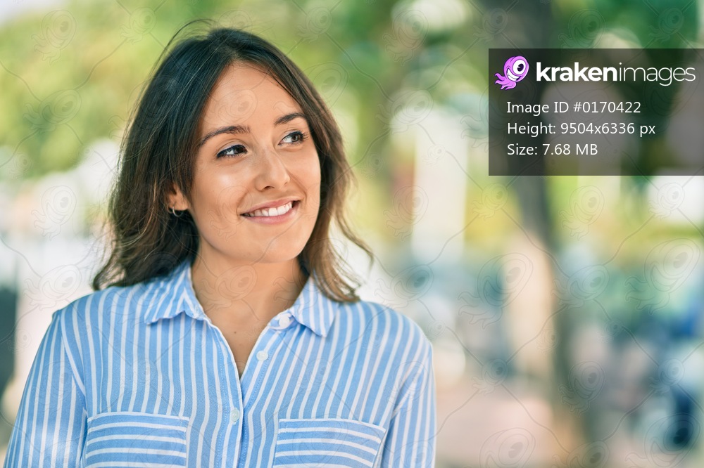 Young hispanic woman smiling happy standing at the park.