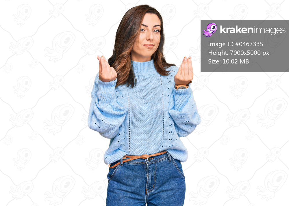 Young brunette woman wearing casual winter sweater doing money gesture with hands, asking for salary payment, millionaire business 