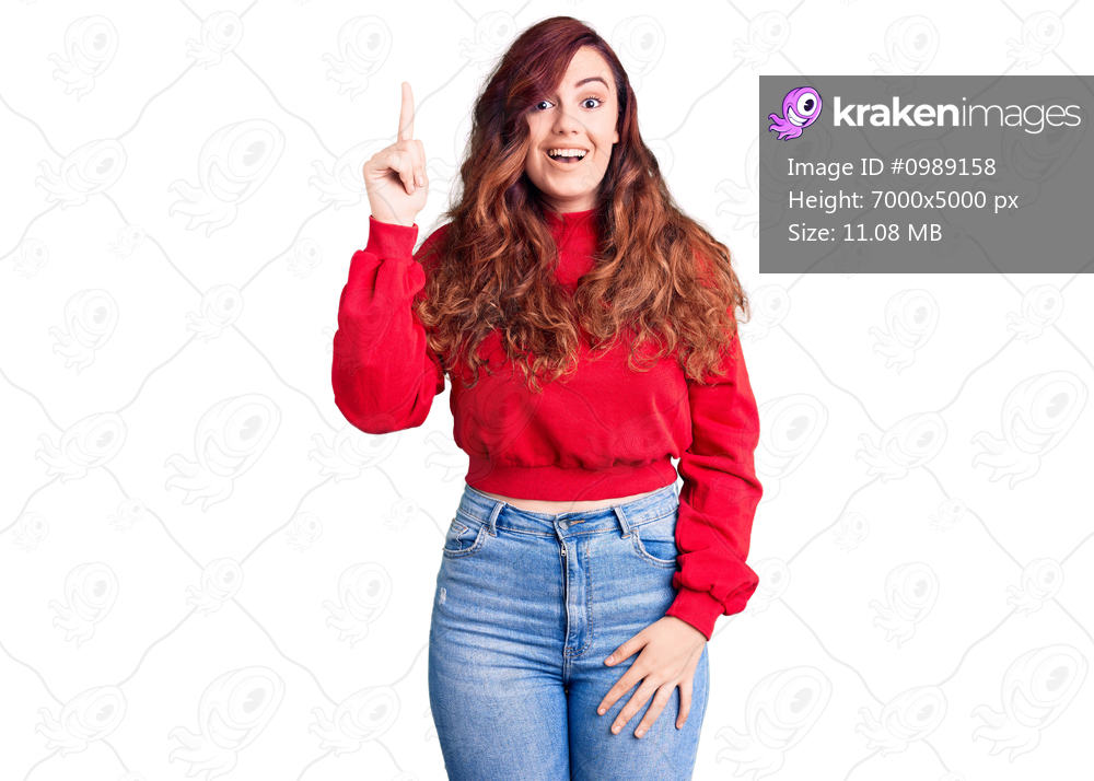Young beautiful woman wearing casual winter sweater pointing finger up with successful idea. exited and happy. number one. 