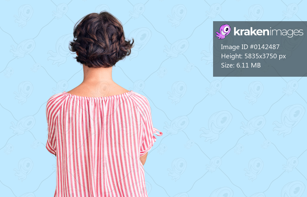 Beautiful young woman with short hair wearing casual summer clothes standing backwards looking away with crossed arms 
