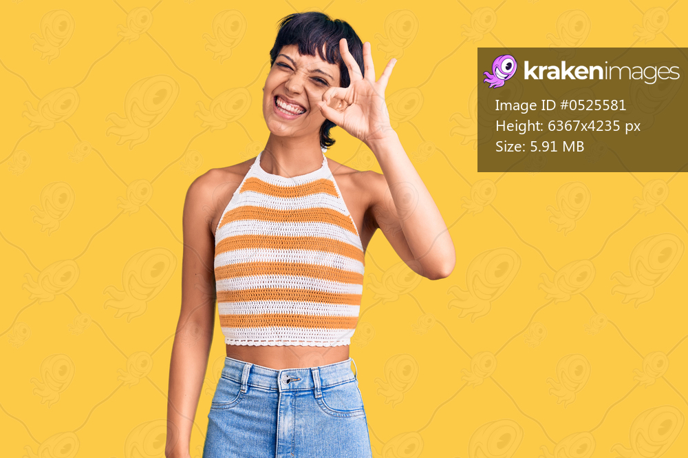 Young brunette woman with short hair wearing casual clothes smiling positive doing ok sign with hand and fingers. successful expression. 