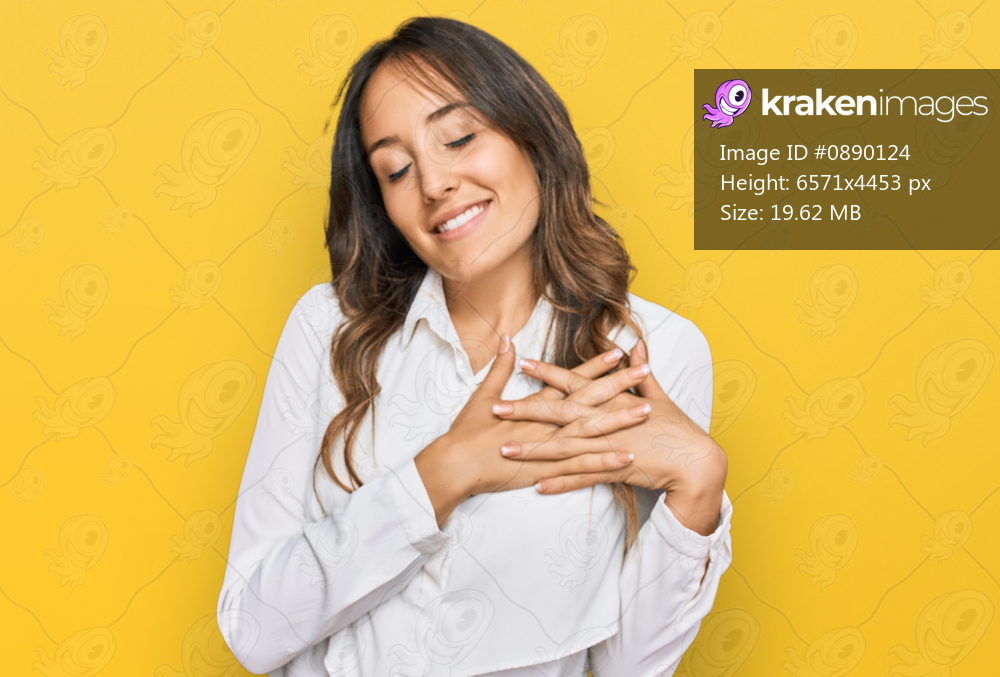 Young brunette woman wearing casual clothes smiling with hands on chest with closed eyes and grateful gesture on face. health concept. 