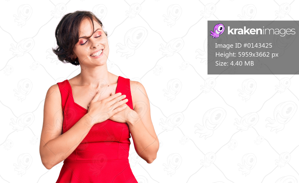 Beautiful young woman with short hair wearing casual style with sleeveless shirt smiling with hands on chest with closed eyes and grateful gesture on face. health concept. 