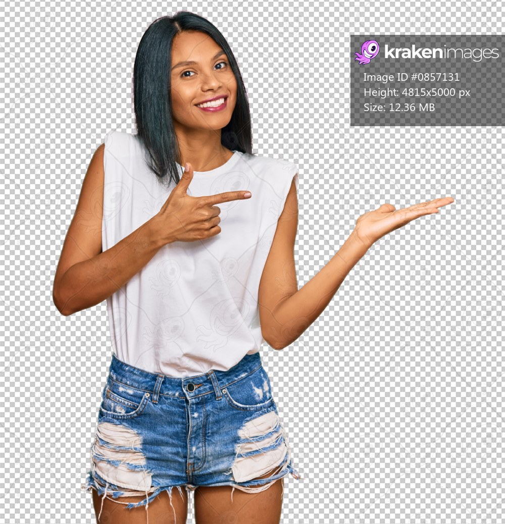 Young african american woman wearing casual clothes amazed and smiling to the camera while presenting with hand and pointing with finger.