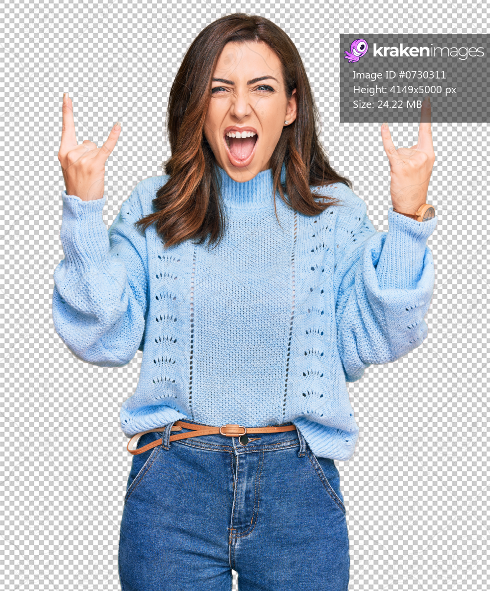 Young brunette woman wearing casual winter sweater shouting with crazy expression doing rock symbol with hands up. music star. heavy music concept.