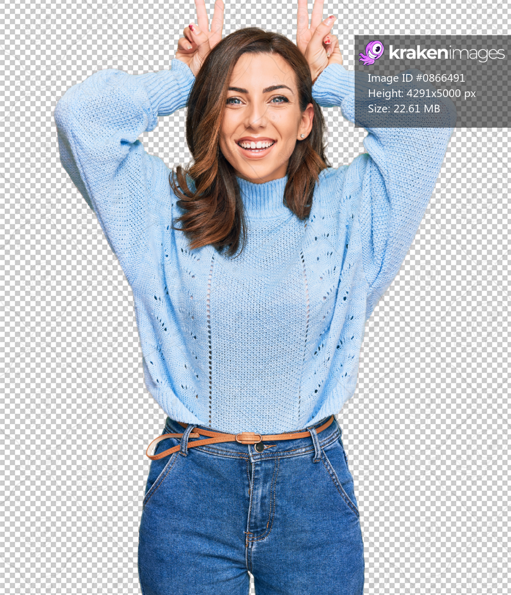 Young brunette woman wearing casual winter sweater posing funny and crazy with fingers on head as bunny ears, smiling cheerful
