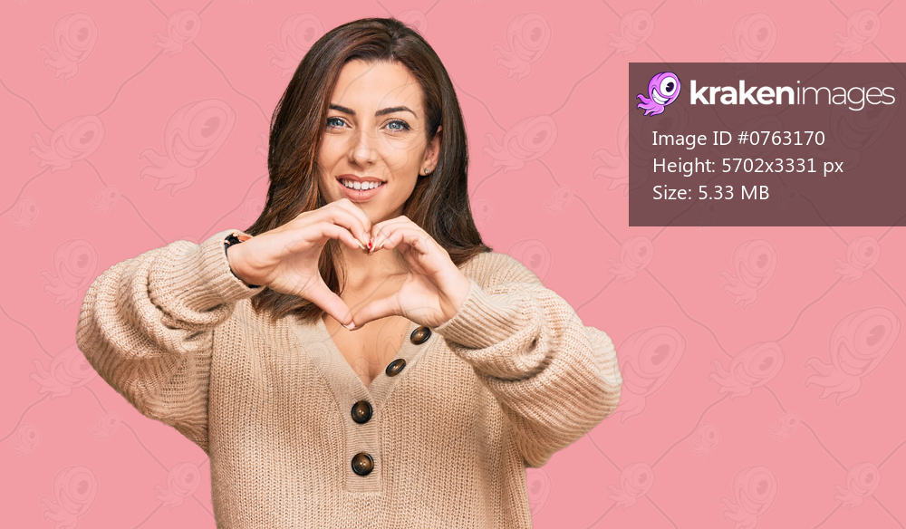 Young brunette woman wearing casual winter sweater smiling in love doing heart symbol shape with hands. romantic concept. 