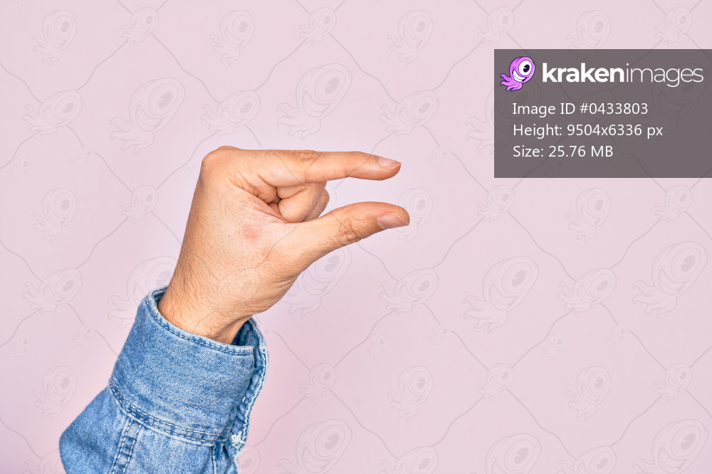 Hand of caucasian young man showing fingers over isolated pink background picking and taking invisible thing, holding object with fingers showing space
