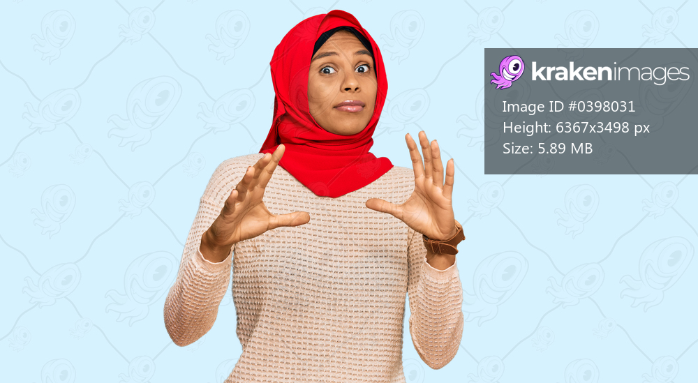 Young african american woman wearing traditional islamic hijab scarf afraid and terrified with fear expression stop gesture with hands, shouting in shock. panic concept. 