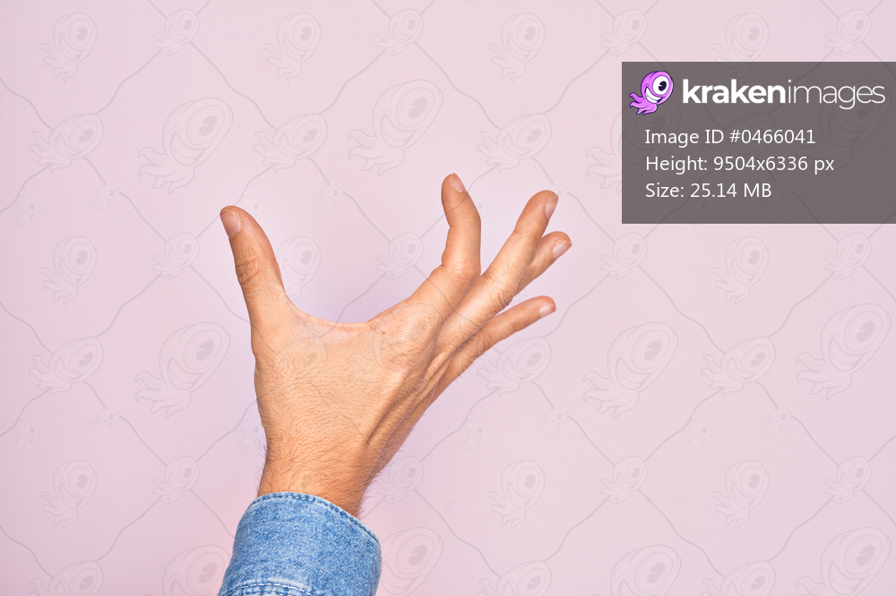 Hand of caucasian young man showing fingers over isolated pink background picking and taking invisible thing, holding object with fingers showing space