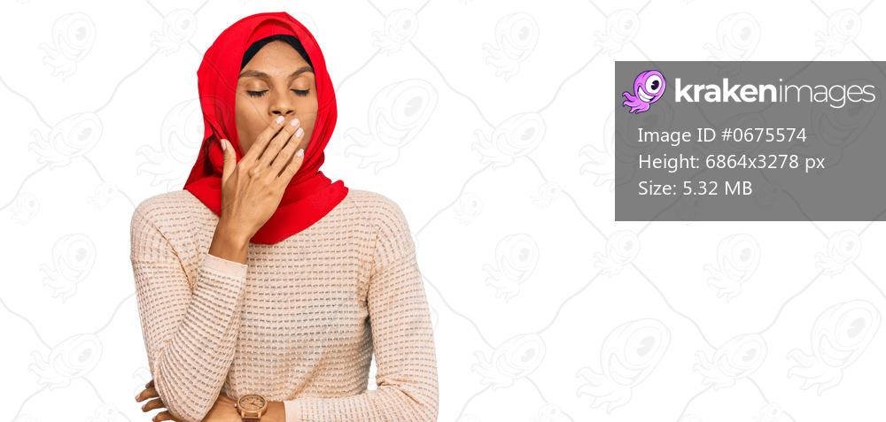 Young african american woman wearing traditional islamic hijab scarf bored yawning tired covering mouth with hand. restless and sleepiness. 