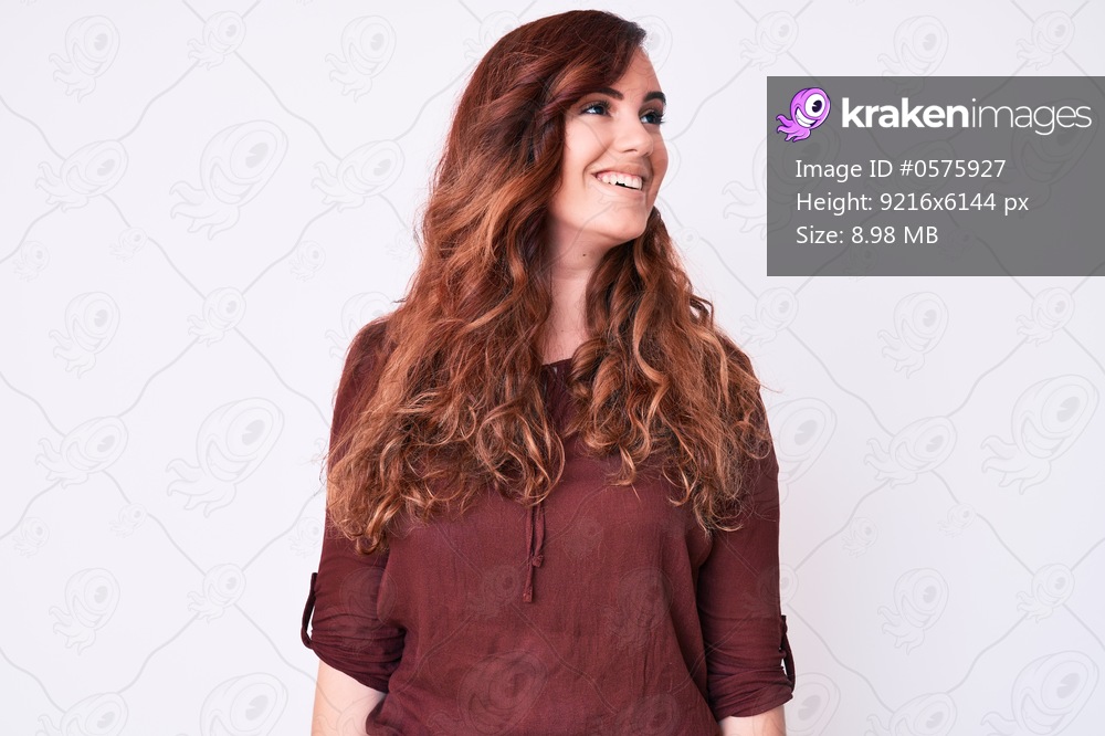 Young beautiful woman wearing casual clothes looking away to side with smile on face, natural expression. laughing confident. 