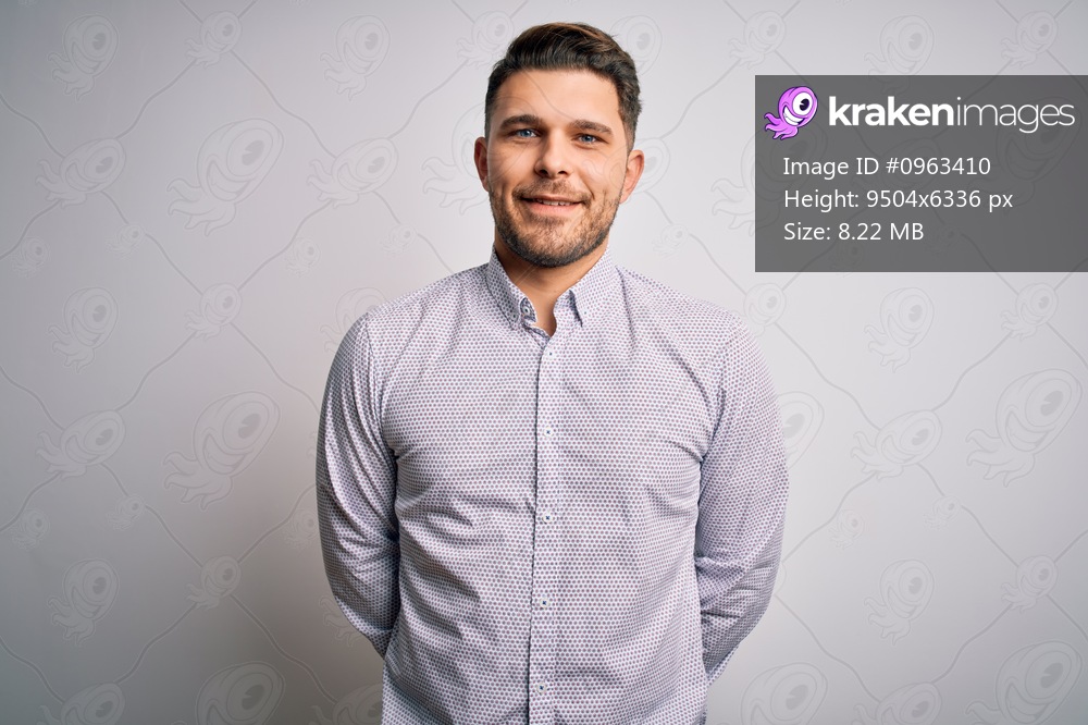 Young business man with blue eyes standing over isolated background with a happy and cool smile on face. Lucky person.