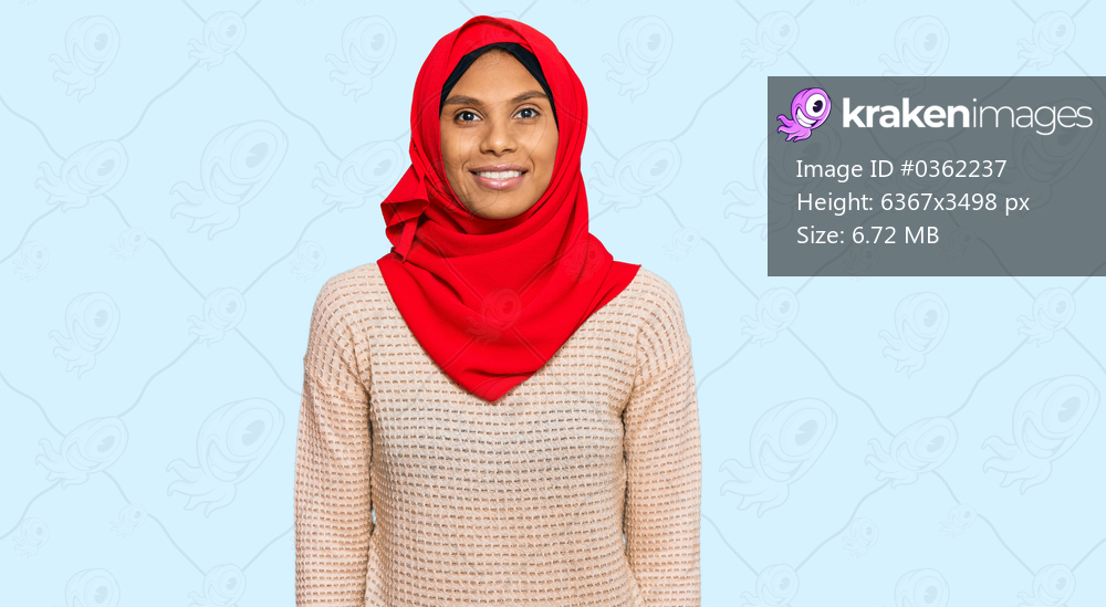 Young african american woman wearing traditional islamic hijab scarf with a happy and cool smile on face. lucky person. 