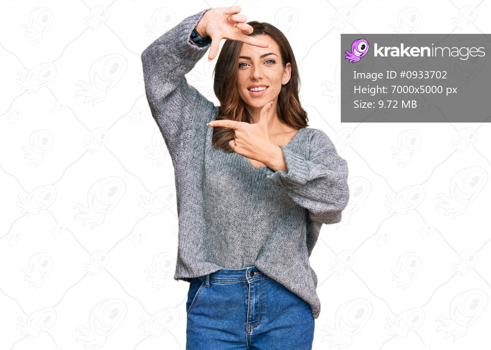 Young brunette woman wearing casual winter sweater smiling making frame with hands and fingers with happy face. creativity and photography concept. 
