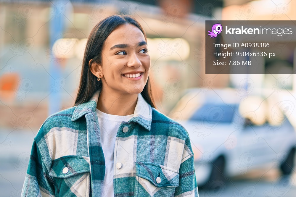 Young latin girl smiling happy standing at the city.