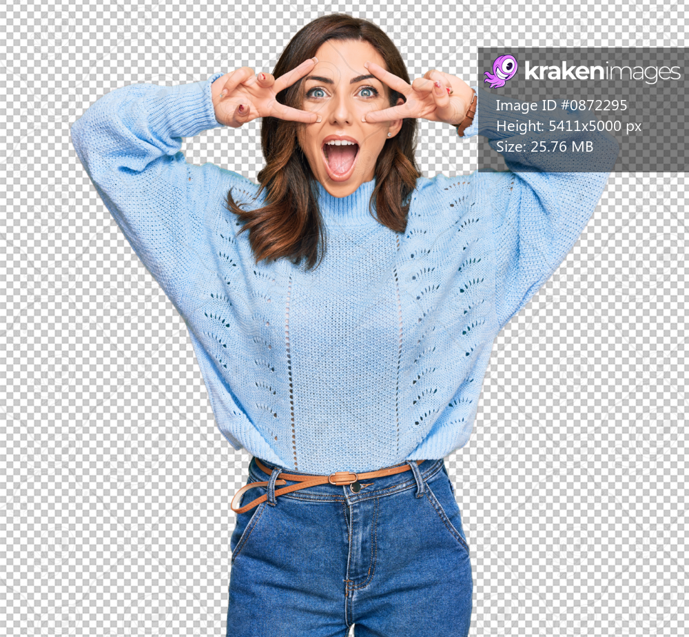 Young brunette woman wearing casual winter sweater doing peace symbol with fingers over face, smiling cheerful showing victory