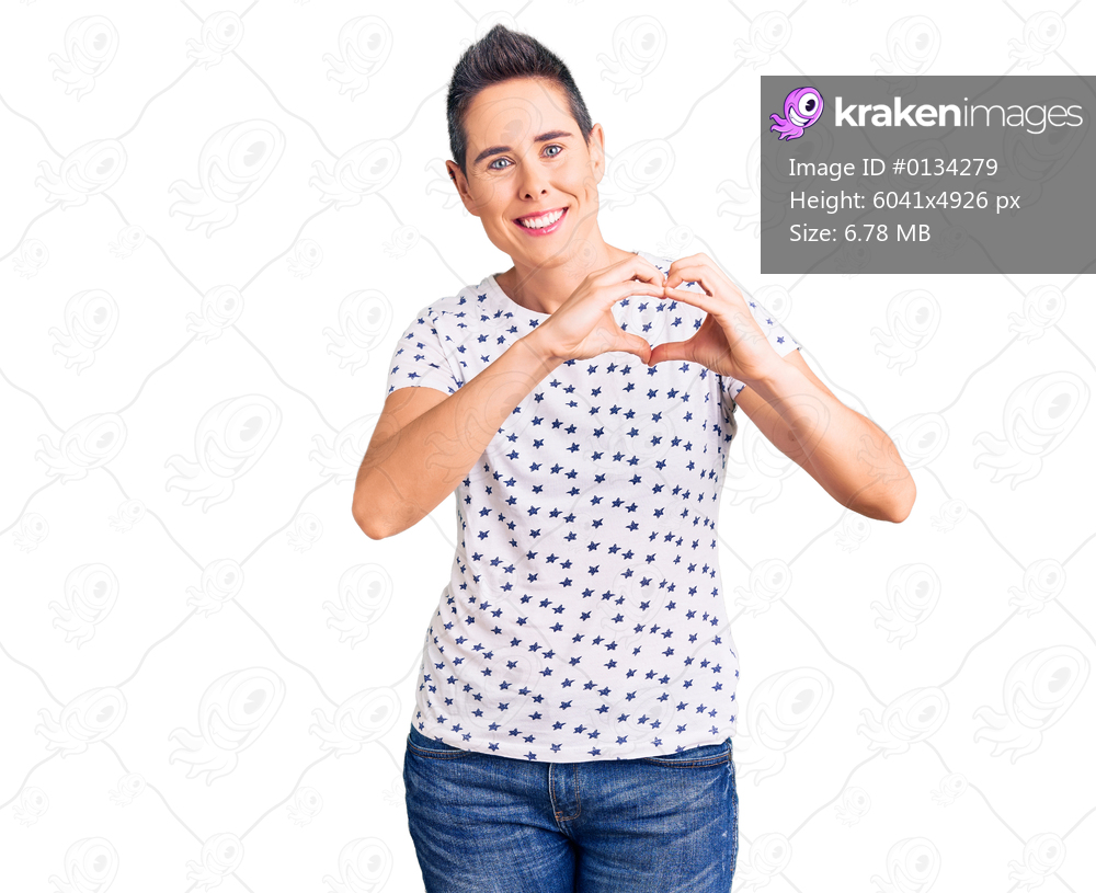 Young woman with short hair wearing casual clothes smiling in love showing heart symbol and shape with hands. romantic concept. 