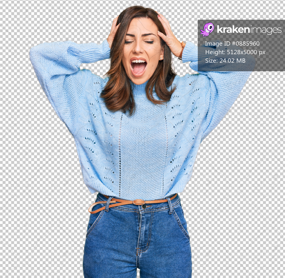 Young brunette woman wearing casual winter sweater crazy and scared with hands on head, afraid and surprised of shock with open mouth
