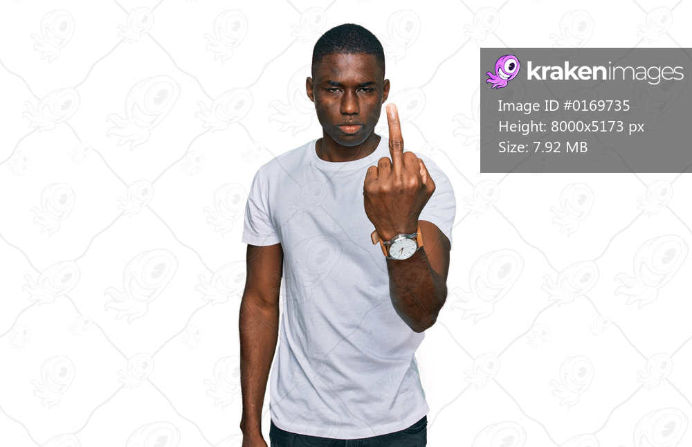 Young african american man wearing casual white t shirt showing middle finger, impolite and rude fuck off expression 