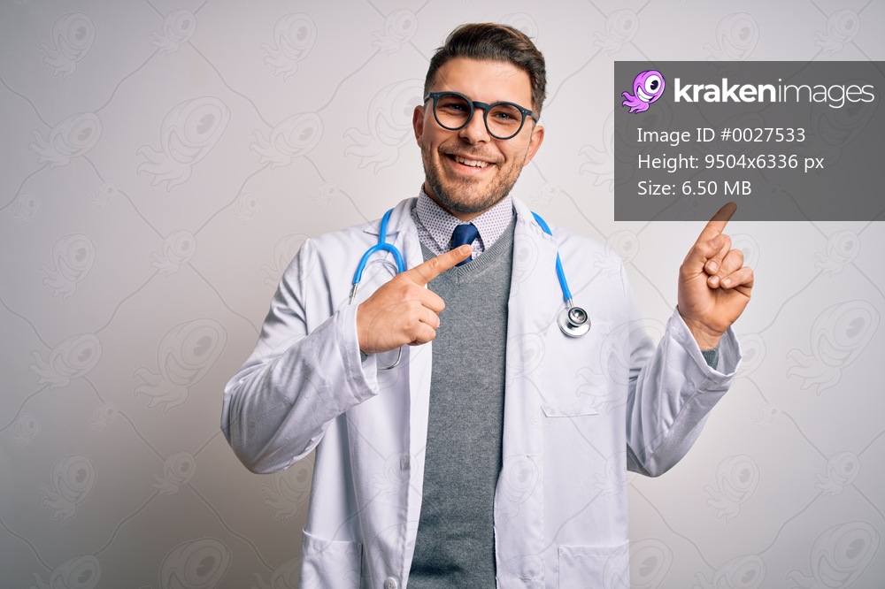 Young doctor man with blue eyes wearing medical coat and stethoscope over isolated background smiling and looking at the camera pointing with two hands and fingers to the side.