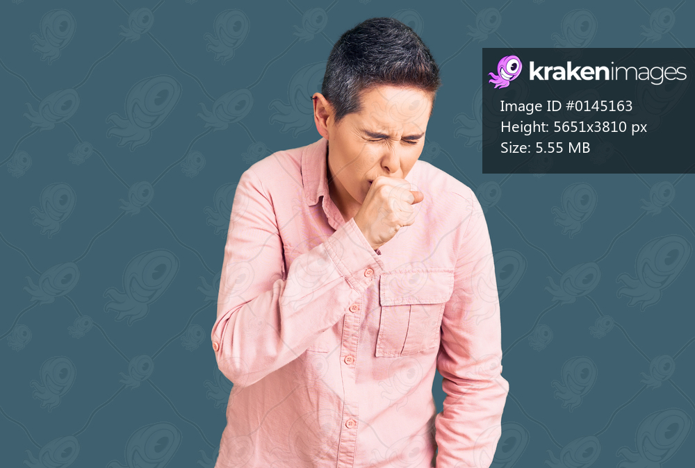 Young woman with short hair wearing casual clothes feeling unwell and coughing as symptom for cold or bronchitis. health care concept. 