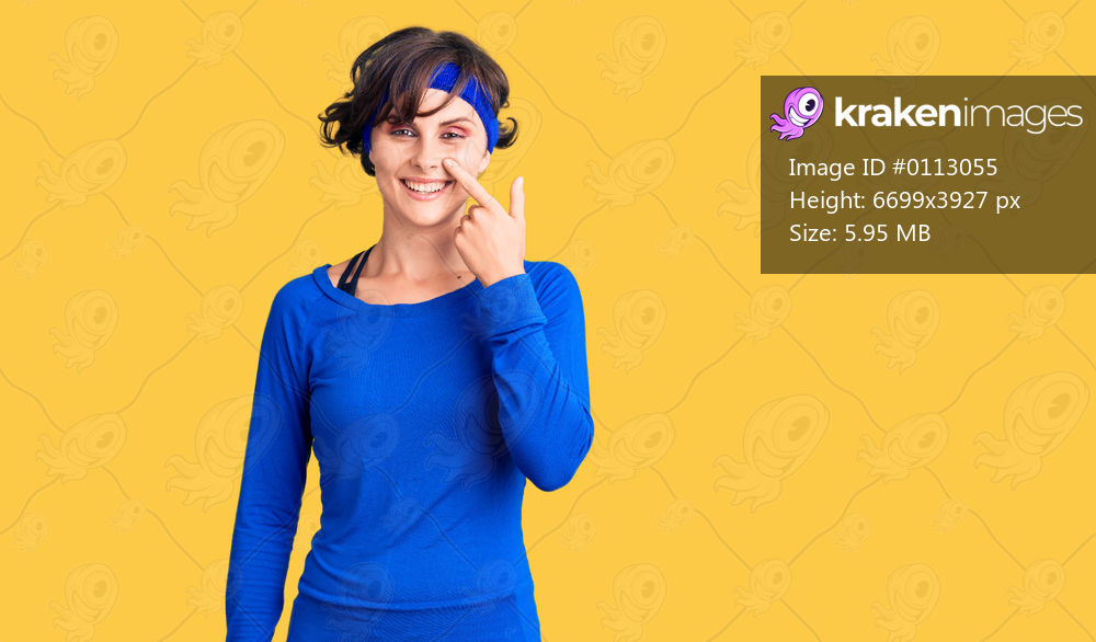 Beautiful young woman with short hair wearing training workout clothes pointing with hand finger to face and nose, smiling cheerful. beauty concept 